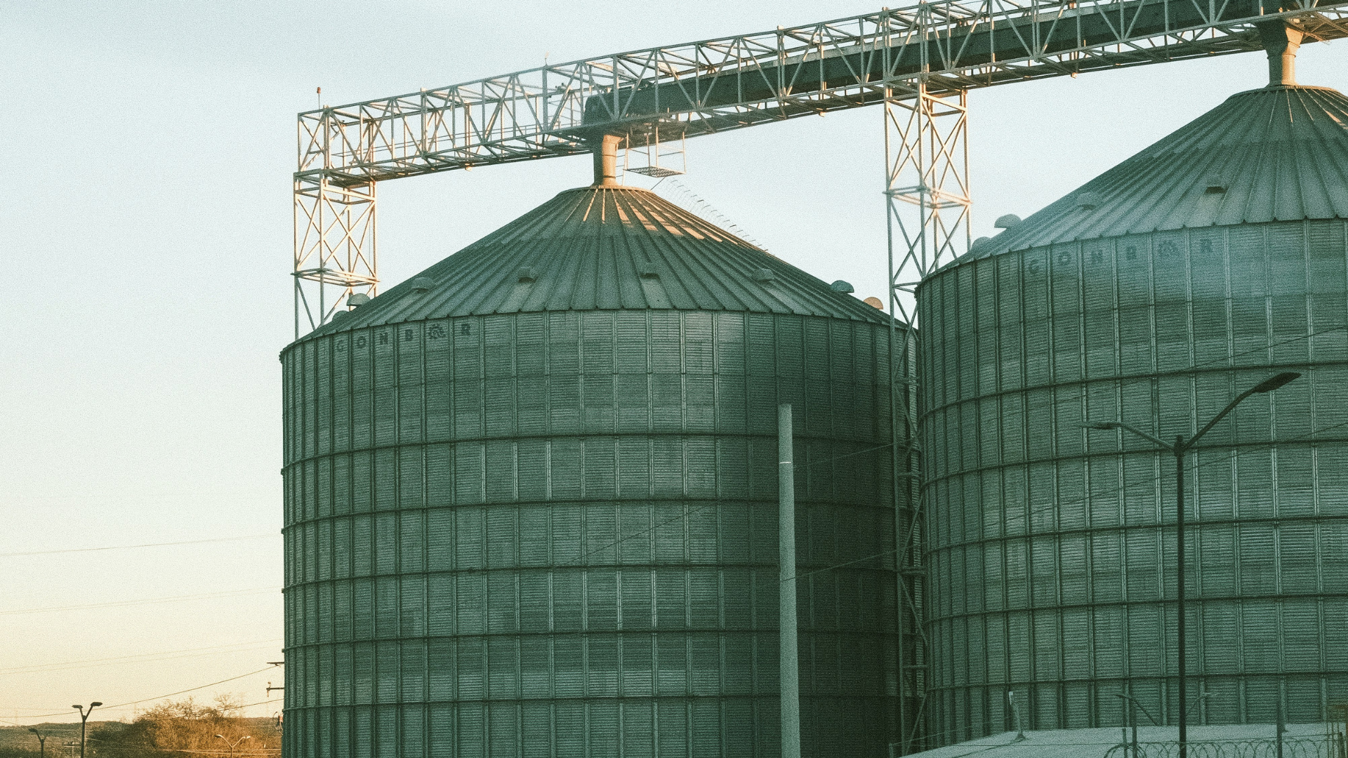 grain bins with sunset